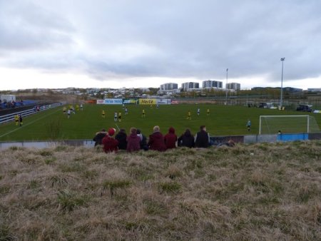 From the 'stand' behind the goal.